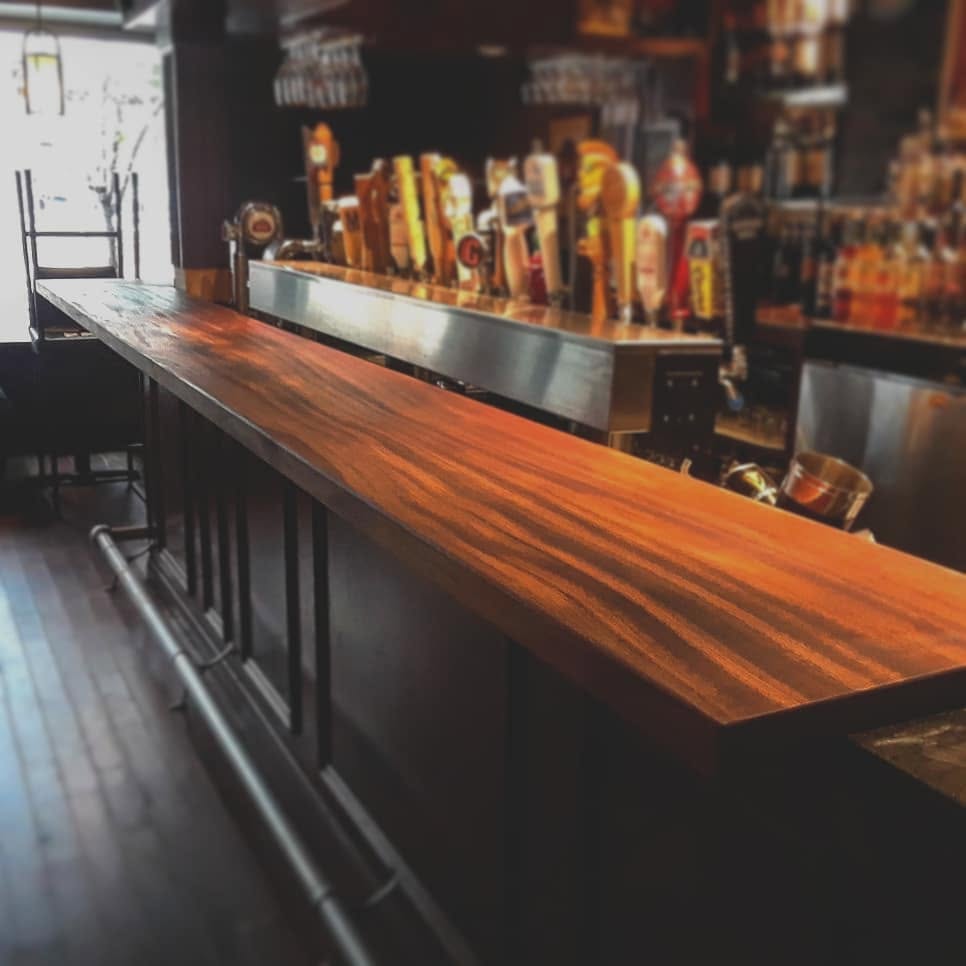 Custom mahogany wood bar counter installation