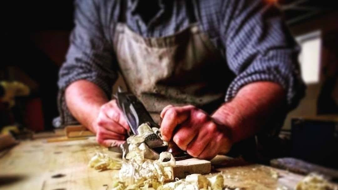Action shot of planing wood by hand