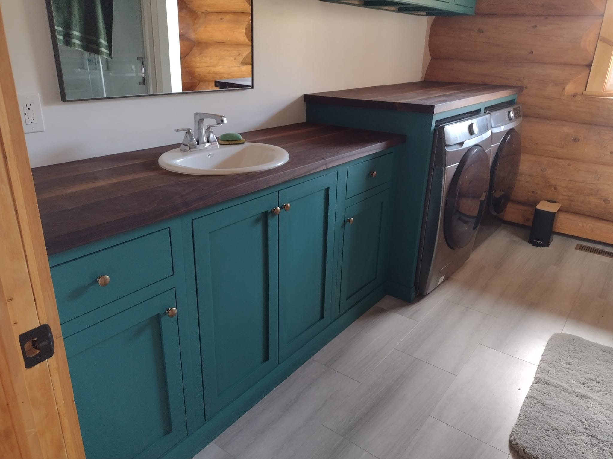 Log Cabin laundry room cabinetry with walnut tops